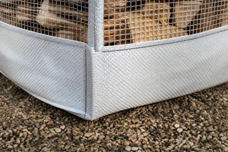 Gros plan sur un big bag pour bois de chauffage avec ses parois en toile moustiquaire